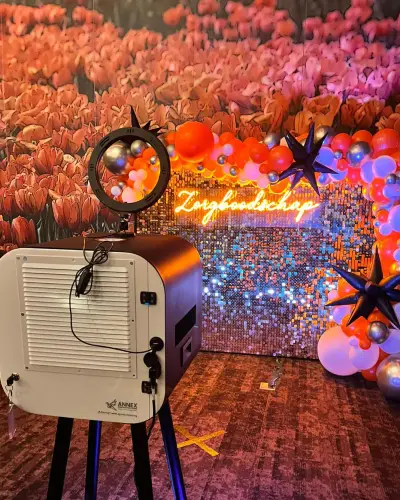 Photo booth and floral backdrop at a gala